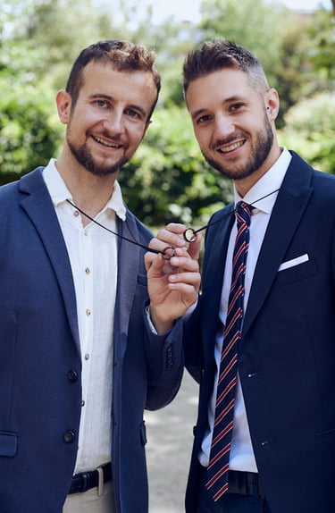 Gay couple holding their weddings bands.
