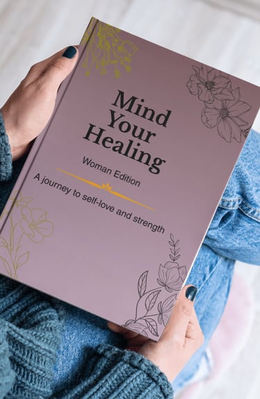 A person holding a purple Mind Your Healing self-love journal for women with floral designs.