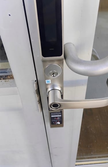 Biometric keypad smart lock installed on commercial building entrance Asheville
