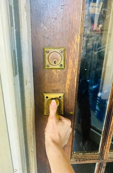 Hand on home door during lockout— representing emergency residential service locksmith in Candler, NC