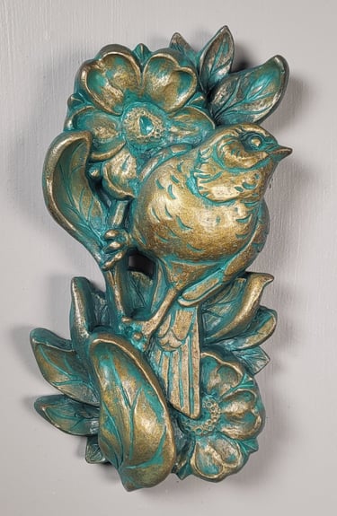 Sculpture of a sparrow perched  on a flower stem. Traditional tattoo inspired art. 