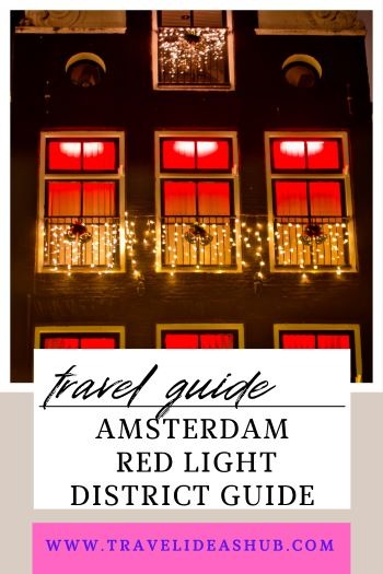 Illuminated red windows of a building in the Amsterdam Red Light District at night.