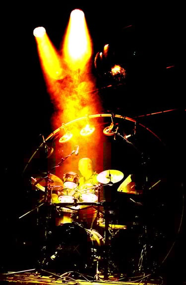 drum rig and drummer on stage with spotlight