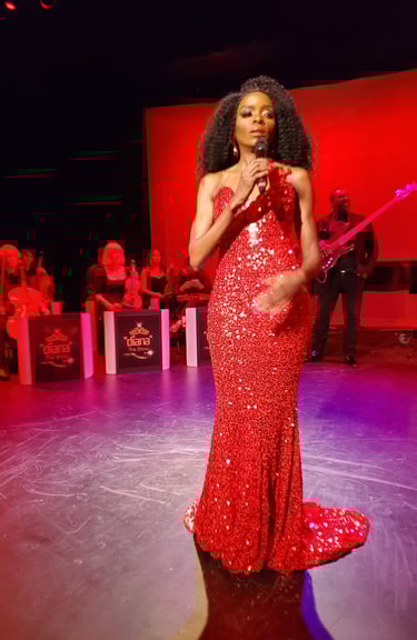 a woman in a red dress standing in front of a microphone