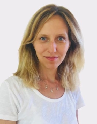 a woman with blonde hair and a white shirt