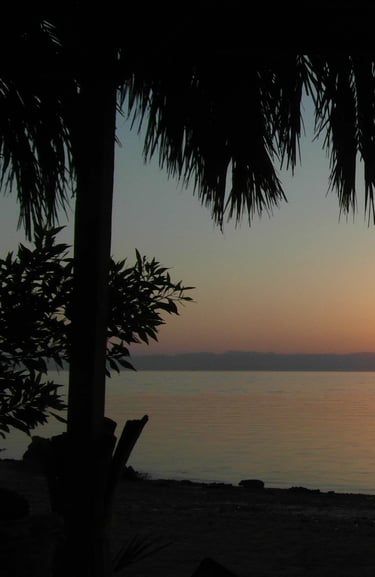 a sunrise over the red sea with a view of the sun rising
