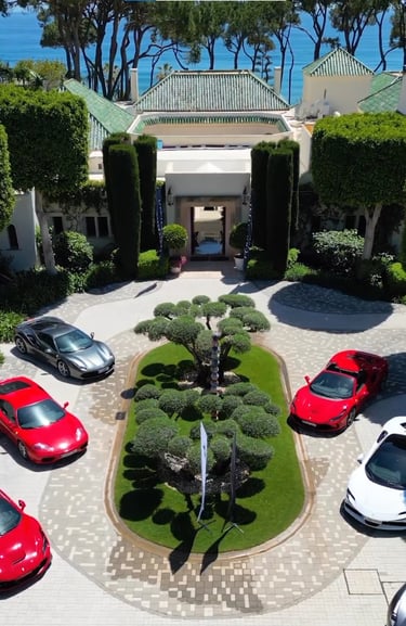 Corporate event at Villa El Rincon featuring luxury sports cars displayed in the courtyard