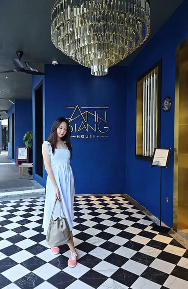 lady posing under grand chandelier | olio my shop  