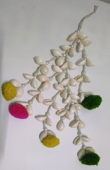 "Handmade shell hair tassel with colorful artificial flower ends–tribal-inspired accessory-Designed for export"
