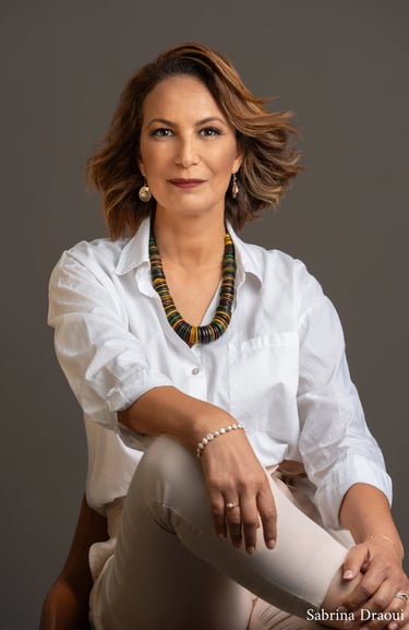 a corporate woman in a white shirt and a necklace