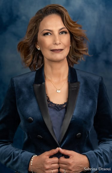 a corporate woman in a blue jacket and a necklace