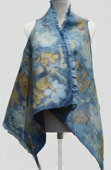 Handmade blue nuno felted vest with botanical leaf prints on a white mannequin torso.