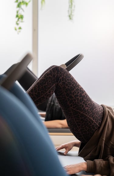 woman doing pilates with pilates ring between knees