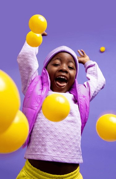 Child happily playing with balls