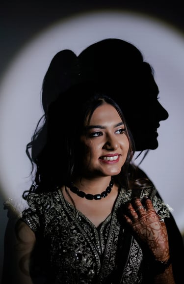 Creative bridal portrait with shadow light effect showing Indian bride with natural glowing bridal m