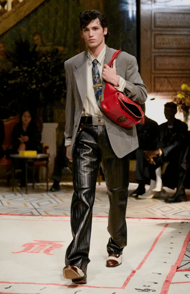 Versace Spring Summer 2026 – Grey blazer with leather trousers and red bag.