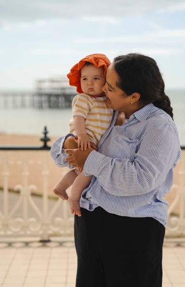 Mother holding her baby on the arms and smiling