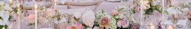 Romantic destination wedding dinner setup with floral centerpieces and candles at Villa El Rincon