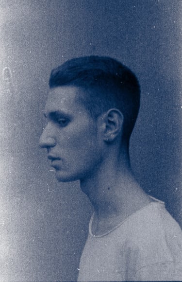 a man with a short haircut and a white shirt in a analogue 35mm photo