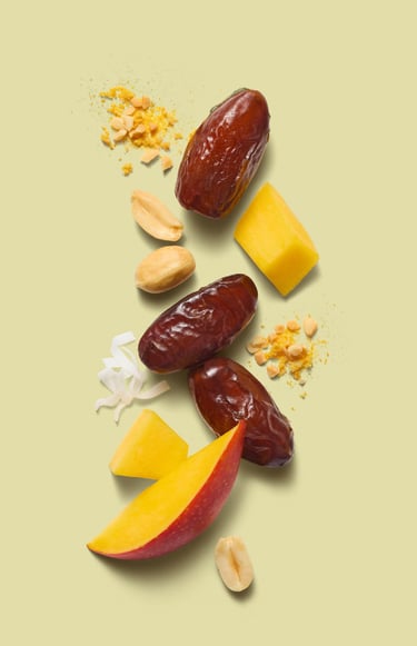 Food and packaging photography - dates and fruit and coconut on a green background