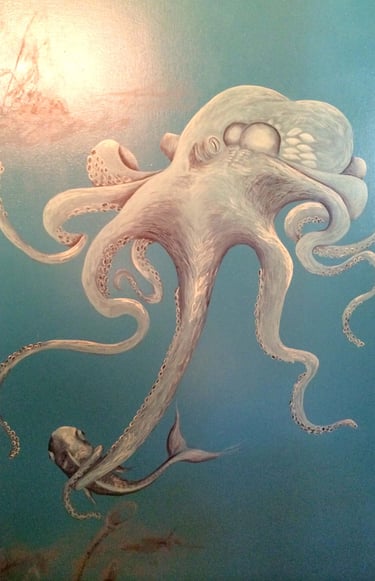 Bathroom mural in marine blues and greys of octopus with a fish hovering in front of a sunken ship.
