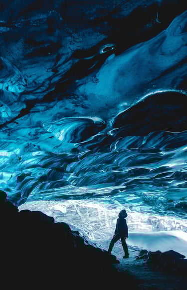 a person standing under a icy cave 