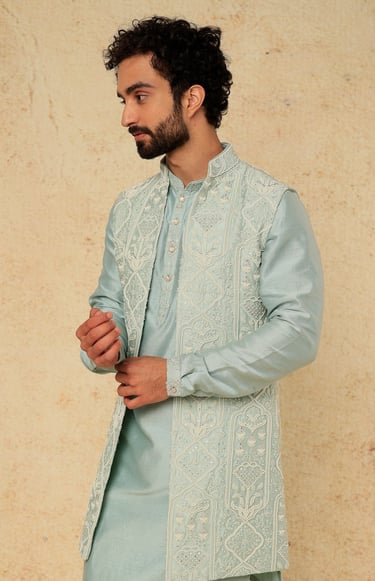 a man in a blue and white suit and a beardless man in a blue