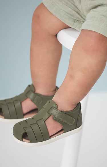 Fashion campaign photography - a baby's feet wearing green sandals