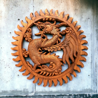 a wooden dragon on a wall with a circular wooden carving