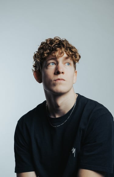 portrait of a man with blue eyes and a black shirt