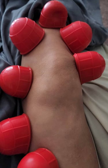 a person with red rubber balls on their feet
