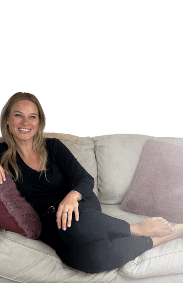 Patricia Vasylchuk, writer, editor, and founder of KingdomCOMM lounges a cream-coloured sofa