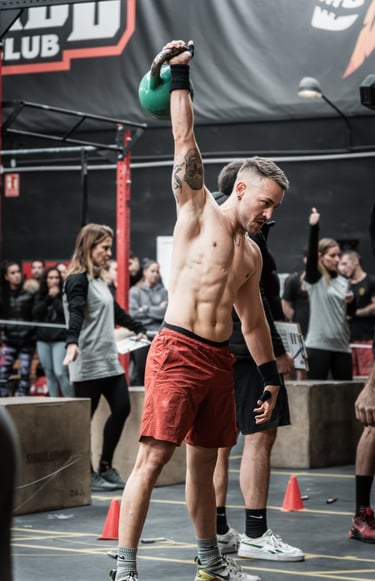 a man holding a kettlebell in a gym