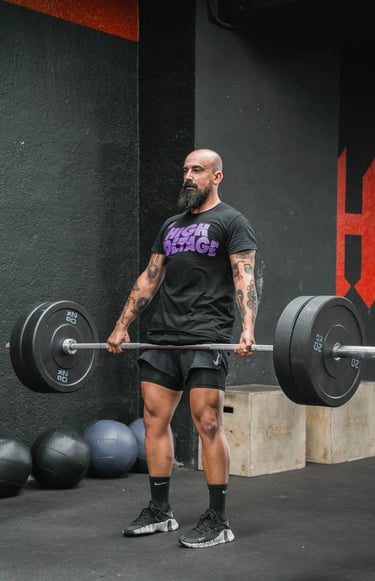 a man with a beard and a beard, holding a barbell
