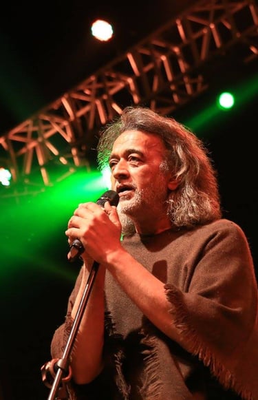 a man in a brown shirt is holding a microphone