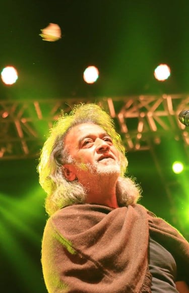 a man with a beard and a beard in a brown jacket