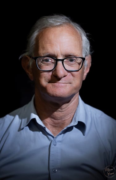 a man with glasses and a blue shirt