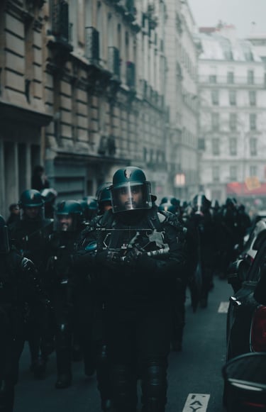 a group of police officers in full riot gear