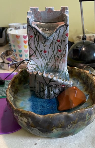 Castle-shaped water fountain and basin