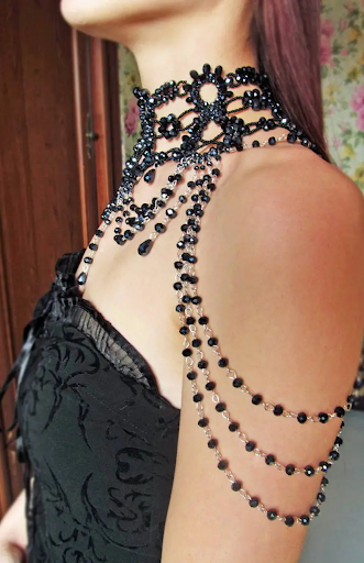 Choker made with delicate silver chain and black jewels, goes down to the shoulders and collar bone.