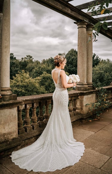 Bride in elegant backless wedding dress captured by Fred Art Studio in London garden