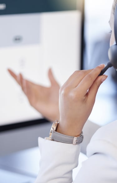 a woman in a white shirt and headphones is holding a headset