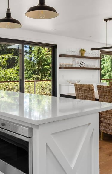 a kitchen with a large window and a table with chairs