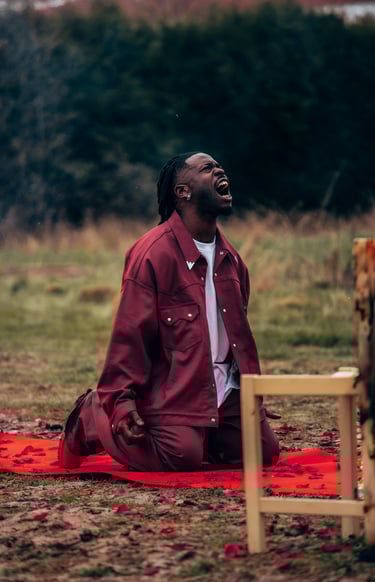 a man, Jok'Air, sitting on a blanket on a blanket
