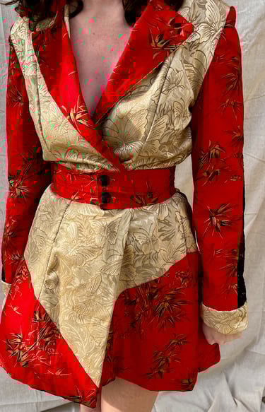 The front of red cotton, black lace, and gold butterfly coat