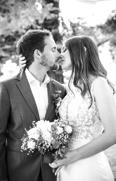 a man and woman kissing in a wedding photo