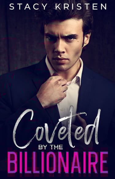 A man in a black suit jacket and white button down shirt, giving a smoldering look.