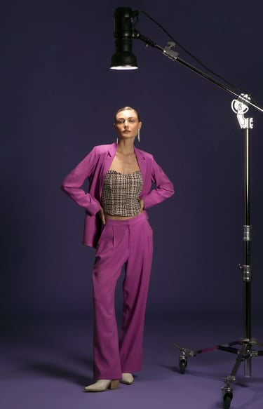 a woman in a purple suit and a camera