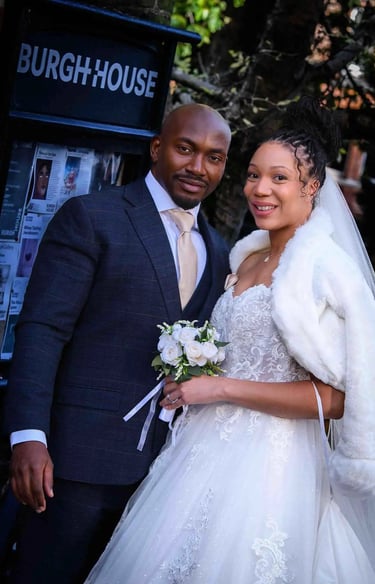 newly-weds standing outside the main gate of Burgh House Hampstead
