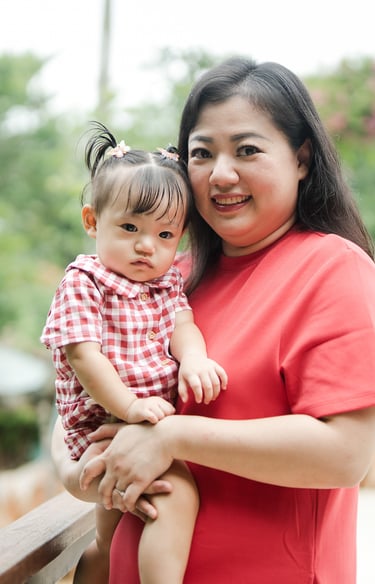 mother holding child in a natural family photography moment at Movenpick Jimbaran Bali resort